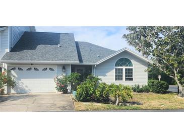 Charming home featuring an attached garage, well maintained landscaping, and a welcoming entrance at 11722 Currie Ln # E1, Largo, FL 33774