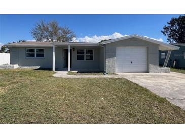 Charming single-story home featuring a one-car garage and well-maintained lawn, perfect for comfortable living at 2016 Essex Dr, Holiday, FL 34691