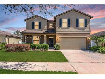 Charming two-story home with a manicured lawn, two car garage, and inviting curb appeal at 2208 Landside Dr, Valrico, FL 33594