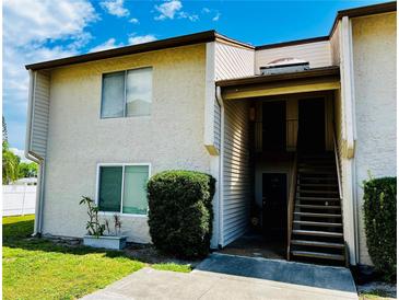 Inviting two-story condo with well-maintained landscaping, stairs leading to the front door, and beautiful curb appeal at 2213 65Th N Ave # 2213, St Petersburg, FL 33702