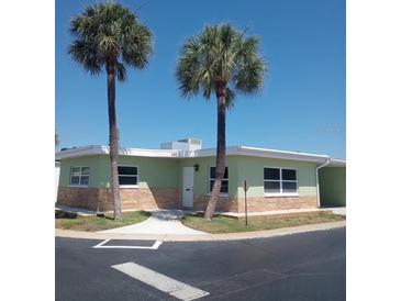 Inviting single-story home with well-kept landscaping and beautiful palm trees at 250 Rosery Nw Rd # 288, Largo, FL 33770