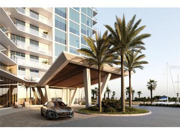 Modern building entrance with porte cochere, palm trees and luxury vehicle at 5120 Marina Way # 21206, Tampa, FL 33611