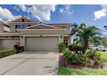 Charming two-story home with lush landscaping, a two-car garage, and a beautiful red tile roof at 5243 6Th Way N, St Petersburg, FL 33703