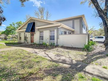 Charming home featuring a modern awning over the front door, complemented by manicured landscaping and a welcoming walkway at 6218 Greenleaf Ln # 6218, Temple Terrace, FL 33617