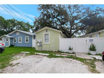 Charming cottage-style home with a quaint fenced yard and ample parking space at 8413 N Hamner Ave # A, Tampa, FL 33604