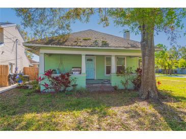 Charming single-story home with a cozy porch and mature landscaping at 313 Jefferson S Ave, Oldsmar, FL 34677