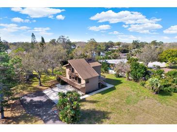 Charming home featuring multi-level decks, lush landscaping, and an expansive yard in a serene setting at 9222 134Th St, Seminole, FL 33776