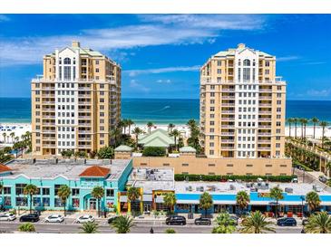 Beautiful waterfront condo buildings with beach views and colorful storefronts below on a sunny day at 11 San Marco St # 307, Clearwater Beach, FL 33767