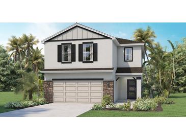 Two-story home featuring a beige garage door, dark shutters, stone accents, and well-manicured landscaping at 17007 Barnwood Pl, Lakewood Ranch, FL 34211
