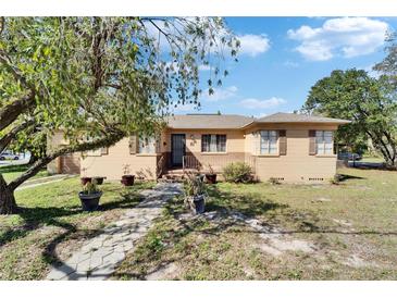 Charming one story home with a welcoming front porch and beautifully landscaped front yard at 2606 N Boulevard, Tampa, FL 33602
