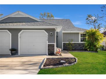 Charming single-Gathering home showcasing a well-manicured lawn and attached one-car garage at 3238 Cloverplace Dr, Palm Harbor, FL 34684