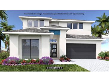 Modern two-story home with a neutral color palette, attached garage, and beautiful tropical landscaping at 430 Sun Chaser Dr, Nokomis, FL 34275