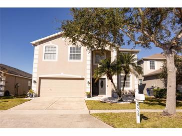 Charming two-story home with a well-maintained lawn and mature trees, offering great curb appeal at 8556 Tidal Bay Ln, Tampa, FL 33635