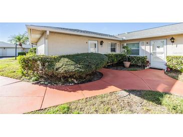 Inviting condo exterior featuring manicured landscaping and a charming walkway to the front entrance at 2175 Corinne S Ct # A, St Petersburg, FL 33712