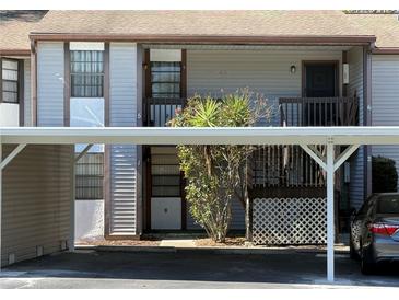 Condominium with tan exterior and carport parking at 12155 Environmental Dr # 6, New Port Richey, FL 34654