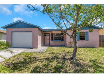 Charming single-story home features a one-car garage and manicured lawn at 12704 128Th Ln, Largo, FL 33774