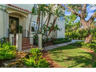Stunning Mediterranean-style home entrance with lush landscaping and a beautifully designed walkway at 2633 N Dundee St, Tampa, FL 33629