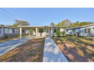 Charming single-story home with a covered carport and a well-maintained front yard at 3218 N 16Th St, Tampa, FL 33605