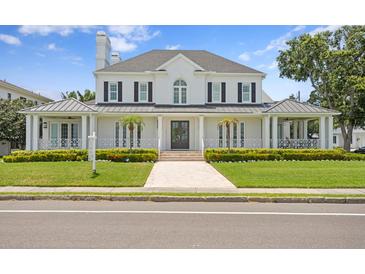 Beautiful two-story home with manicured lawn, a walkway, and a double-door entryway at 3801 Bayshore Blvd, Tampa, FL 33611