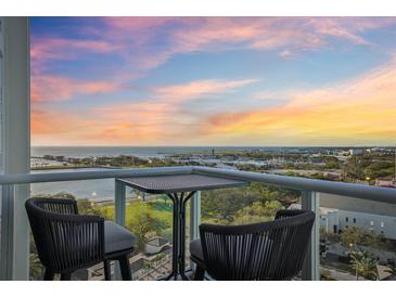 Relaxing balcony showcasing seating with captivating city and ocean views at sunset at 400 Beach Ne Dr # 1202, St Petersburg, FL 33701