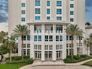 Grand building entrance with lush landscaping, palm trees, and elegant architectural details at 400 Beach Ne Dr # 1202, St Petersburg, FL 33701
