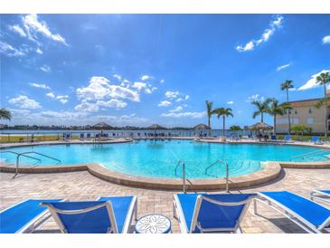 Enjoy the community pool with waterfront views and lounge seating in this relaxing outdoor space at 5220 Brittany S Dr # 807, St Petersburg, FL 33715