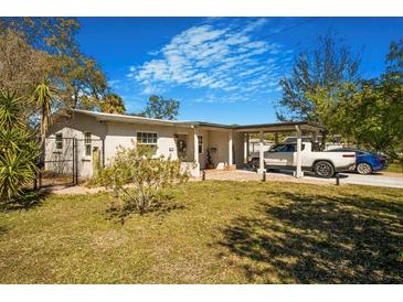 Charming home featuring a covered parking area, lush lawn, and inviting curb appeal at 7101 8Th N Ave, St Petersburg, FL 33710