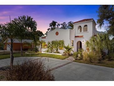 Stunning two-story home featuring a red tile roof, white stucco exterior, and beautiful landscaping at 2227 29Th S St, St Petersburg, FL 33712