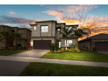 Beautiful two-story home with manicured lawn, landscaped garden, and a paved driveway leading to a two-car garage at 3107 Mountain Spruce Ter, Wesley Chapel, FL 33543