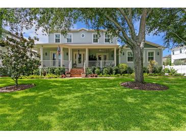 Charming two-story home featuring a spacious front porch, well-manicured lawn, and beautiful landscaping at 5024 W Homer Ave, Tampa, FL 33629