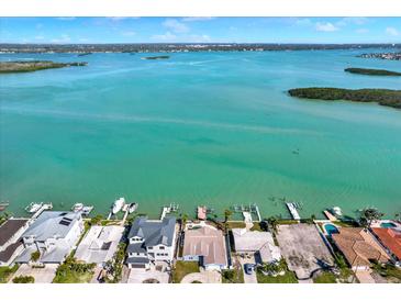 Breathtaking aerial view of waterfront homes with docks on a picturesque coastline at 535 Johns Pass Ave, Madeira Beach, FL 33708