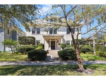 Beautiful two-story home featuring a lush front lawn, trimmed bushes, and an inviting covered entryway at 701 S Edison Ave, Tampa, FL 33606