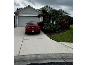 Charming single-story home with well-manicured landscaping, a driveway and an attached garage at 8214 Tabbystone Pl, Bradenton, FL 34201