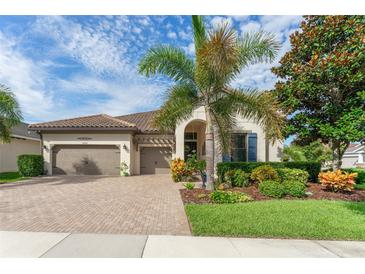 Charming home exterior featuring a well-manicured lawn, paved driveway, and mature landscaping at 14315 Rolling Dune Rd, Lithia, FL 33547