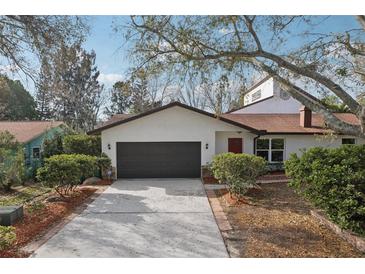Charming single-Gathering home featuring a two-car garage, well-kept landscaping, and a cozy front entrance at 2213 Spanish Vistas Dr, Dunedin, FL 34698