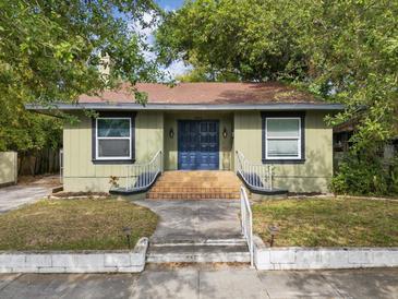 Charming single-story home with a quaint front yard and inviting blue front door at 5604 N Cherokee Ave, Tampa, FL 33604