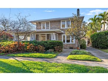 Charming two-story home featuring stone facade, mature landscaping, and a welcoming entrance at 864 15Th Ne Ave, St Petersburg, FL 33704