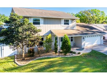 Charming two-story home boasts lush landscaping and a well-manicured lawn, creating a welcoming curb appeal at 1375 Corner Oaks Dr, Brandon, FL 33510