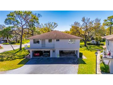 Charming two-story home with covered parking, beautiful landscaping, and a welcoming front porch at 1828 Bough Ave # 3, Clearwater, FL 33760