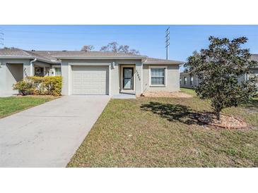 Charming home with a well-maintained lawn and attached one-car garage and neutral color scheme at 37850 Prairie Rose Loop, Zephyrhills, FL 33542