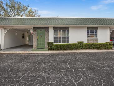 Charming single-story home featuring a green door and well-maintained front yard landscaping at 7816 38Th N Ter # 7816, St Petersburg, FL 33709