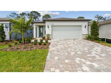 Charming single-story home with well-manicured landscaping and a brick paved driveway at 9470 Shorebird Ct, Parrish, FL 34219