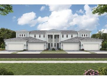 Elegant townhome exterior featuring symmetrical design, multi-car garages, and inviting curb appeal at 12785 Jade Empress Loop # 101, Venice, FL 34293