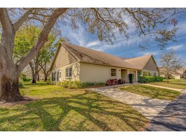 Charming single-story home with well-maintained lawn, mature trees and inviting curb appeal at 2847 Rampart Cir, Clearwater, FL 33761