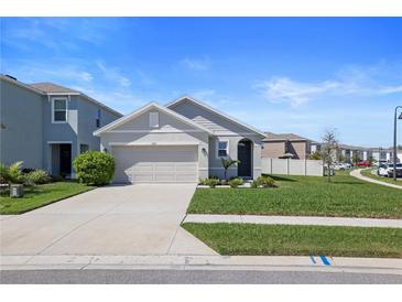 Charming single-Gathering home with a well-manicured lawn and an attached two-car garage at 3135 Suncoast Blend Dr, Odessa, FL 33556