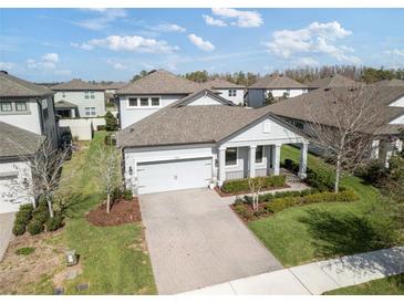 Charming single-Gathering home features an attached two-car garage, well-manicured lawn, and landscaped flower beds at 3991 Mellon Dr, Odessa, FL 33556