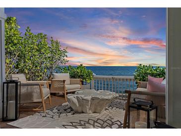 Seating area on patio with stunning sunset views over the Gulf of Mexico at 4966 Coquina Key Se Dr # 4966, St Petersburg, FL 33705