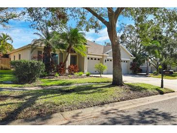 Charming single-Gathering home features a three-car garage and well-maintained landscaping at 10632 Weybridge Dr, Tampa, FL 33626