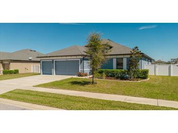Charming single-story home featuring a two-car garage, well-manicured lawn, and beautiful landscaping in a tranquil neighborhood at 12749 Weatherstone Dr, Spring Hill, FL 34609