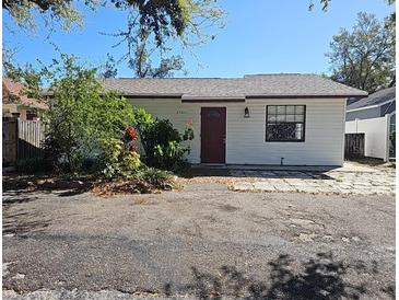Charming single-story home featuring a red front door, white exterior, and small front yard at 4501 67Th N St, St Petersburg, FL 33709
